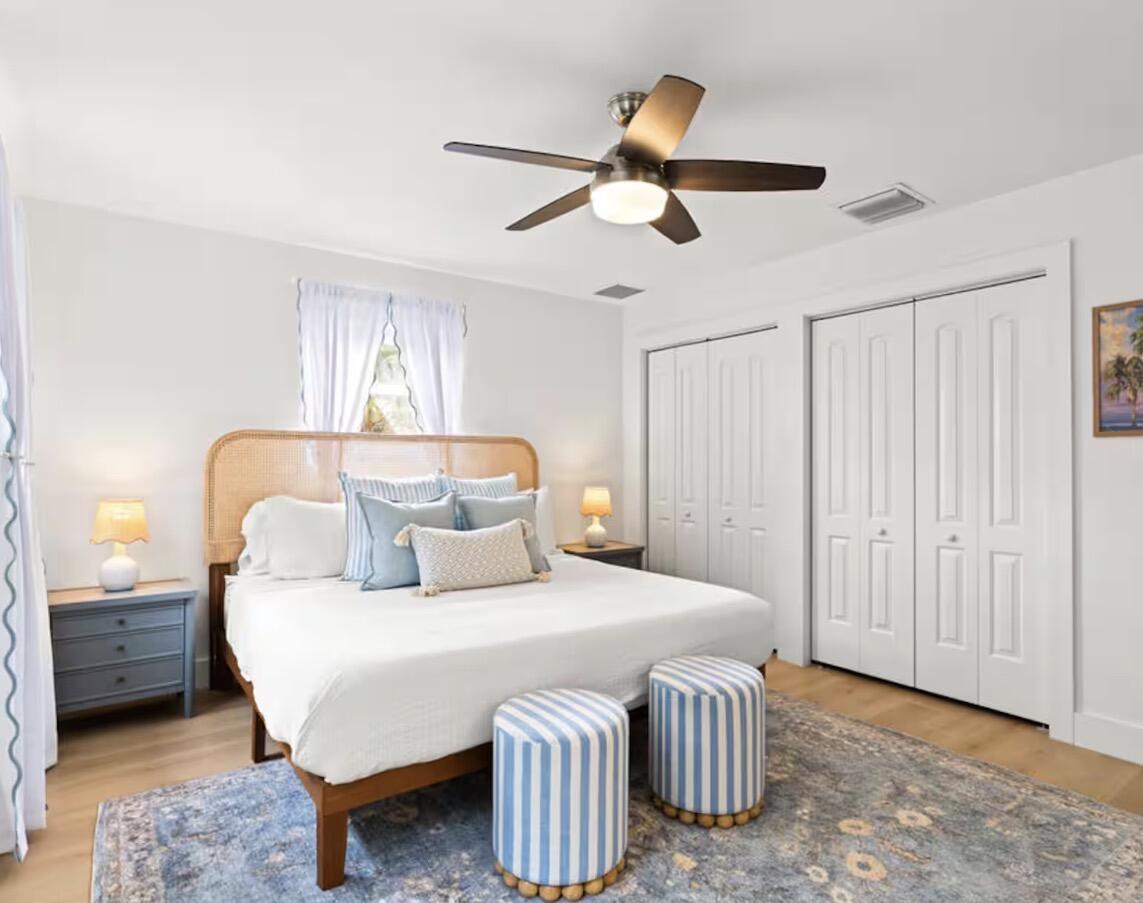 1216 Surf Road Singer Island, FL 33404 - Photo 8 of 15 a bedroom with a bed and a chandelier