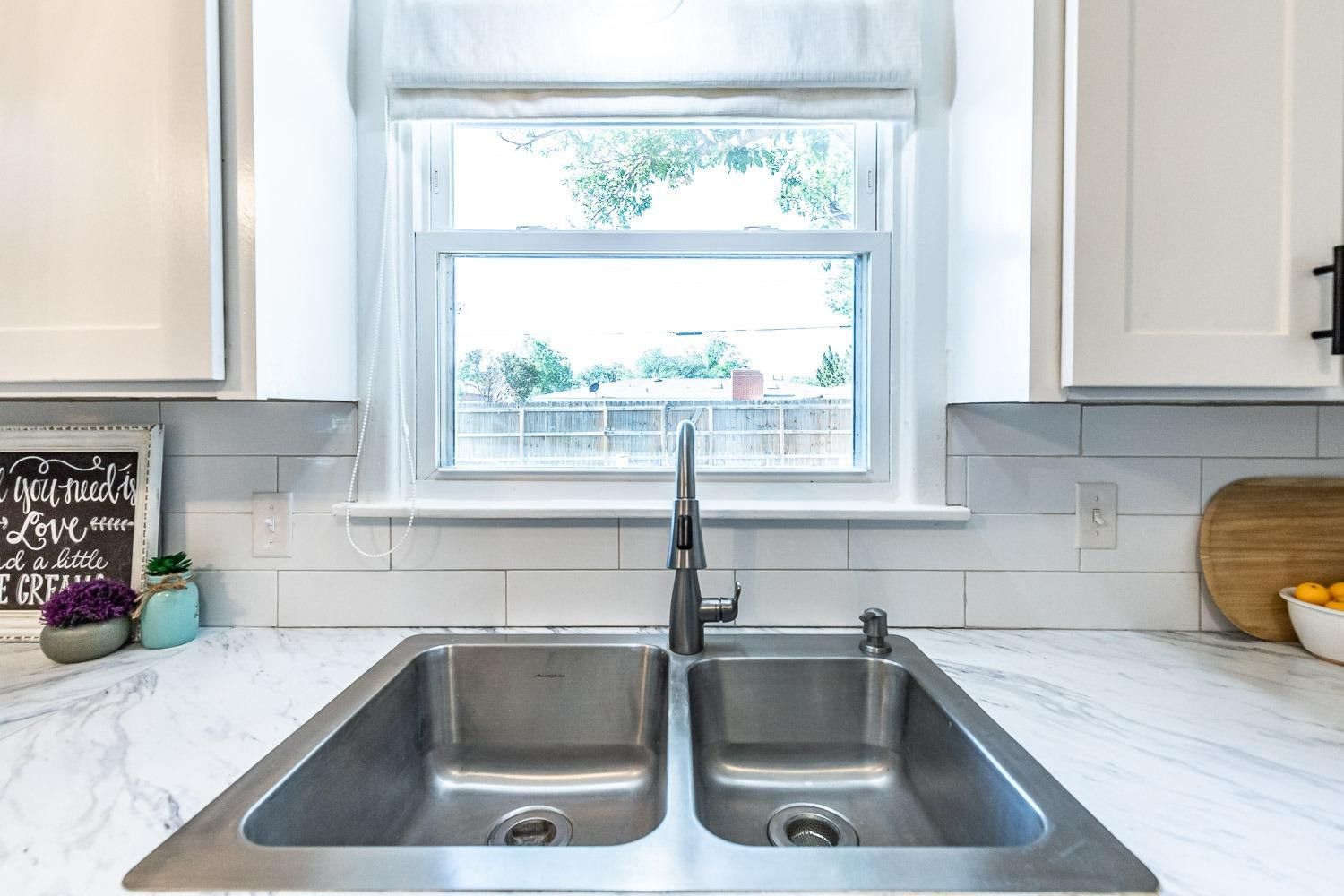 5221 14th Street Lubbock, TX 79416 - Photo 13 of 34 a kitchen with a sink and a window