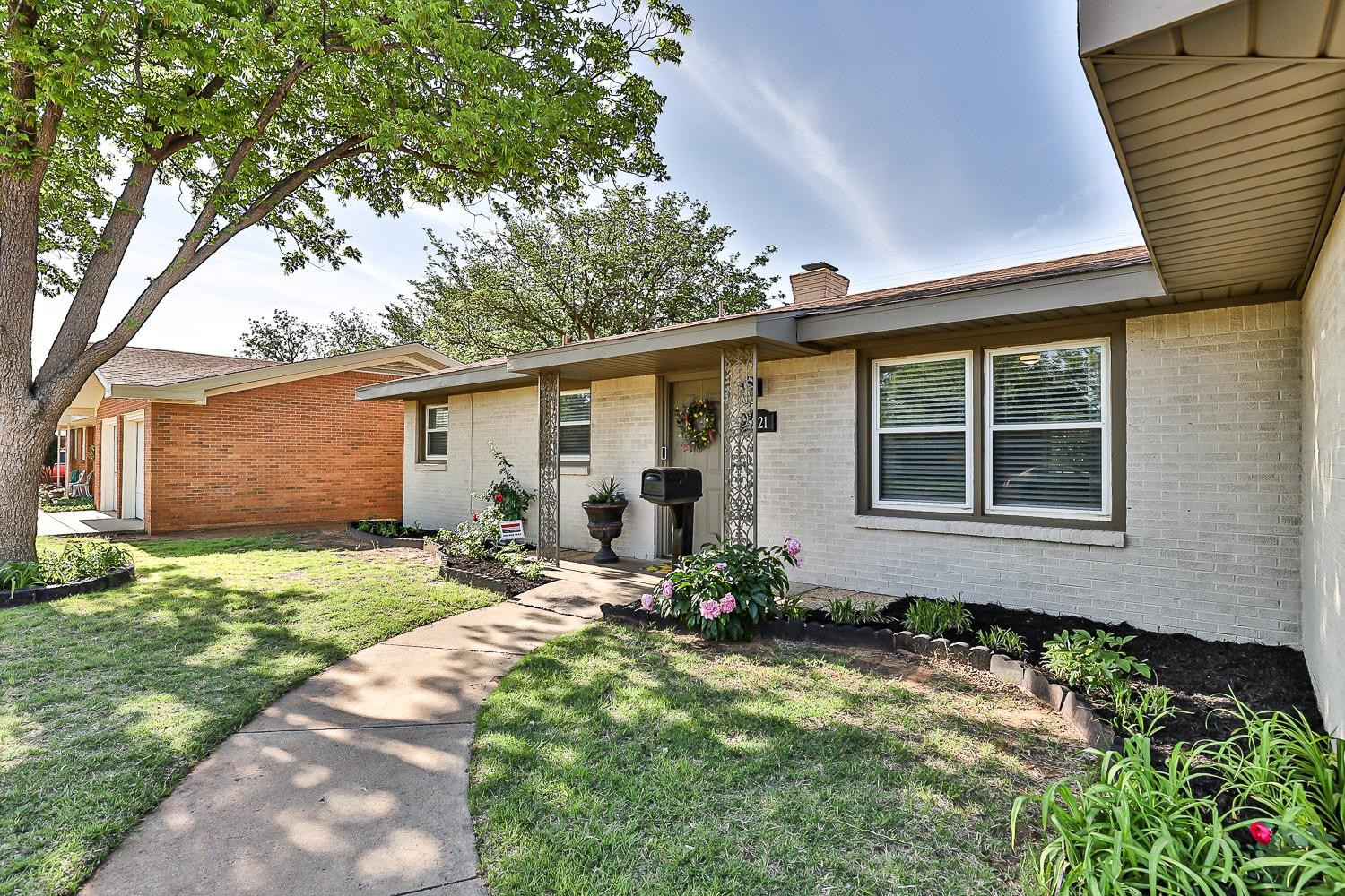 5221 14th Street Lubbock, TX 79416 - Photo 2 of 34 a backyard of a house with seating space
