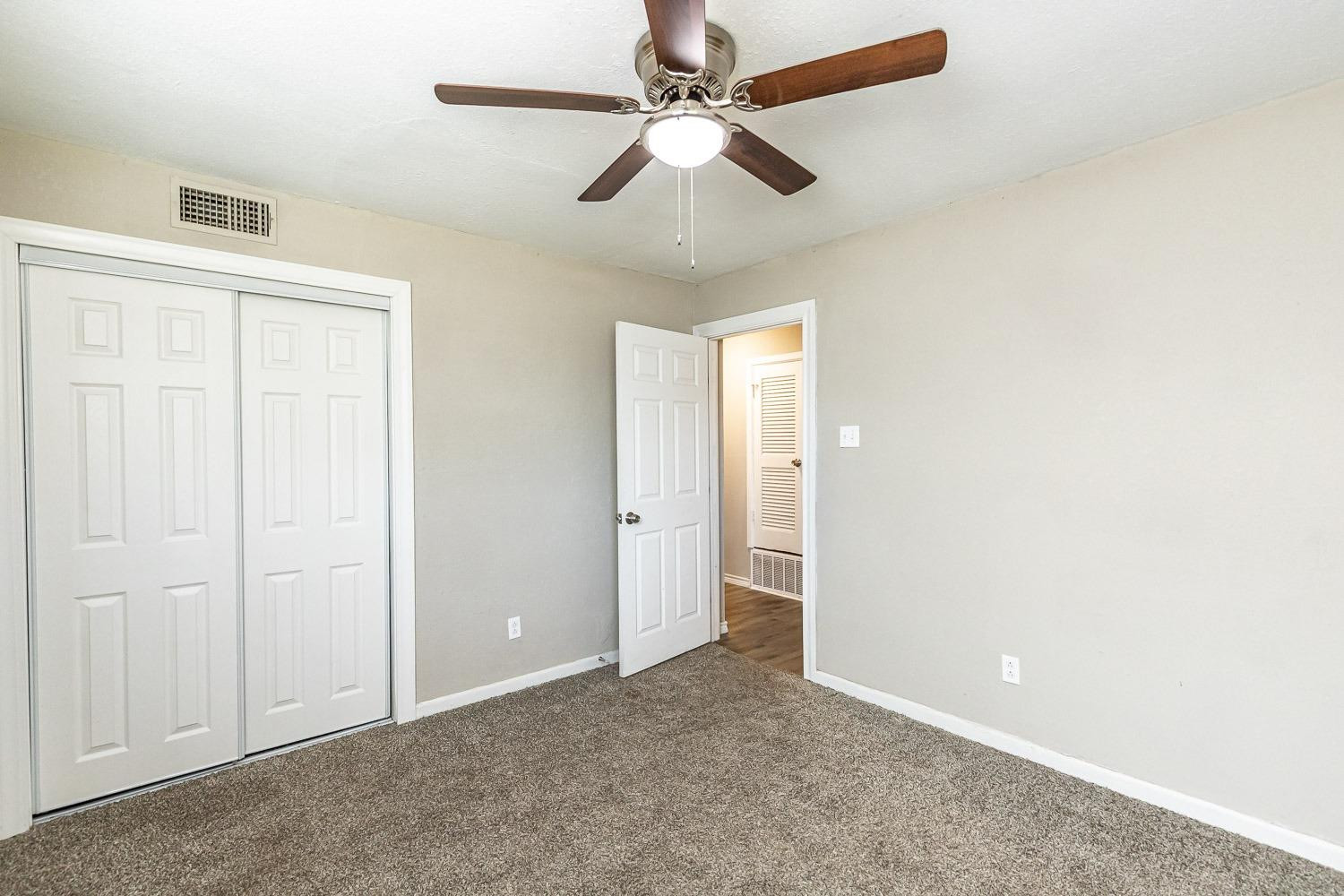 5221 14th Street Lubbock, TX 79416 - Photo 27 of 34 an empty room with chandelier fan