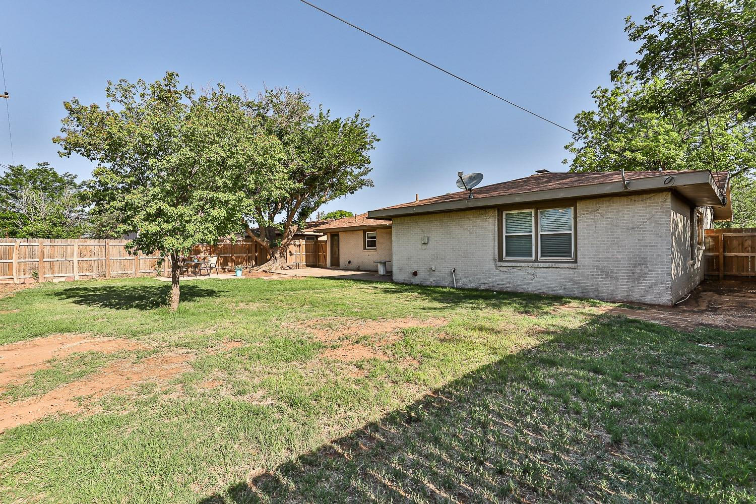 5221 14th Street Lubbock, TX 79416 - Photo 32 of 34 a view of a house with yard and a tree
