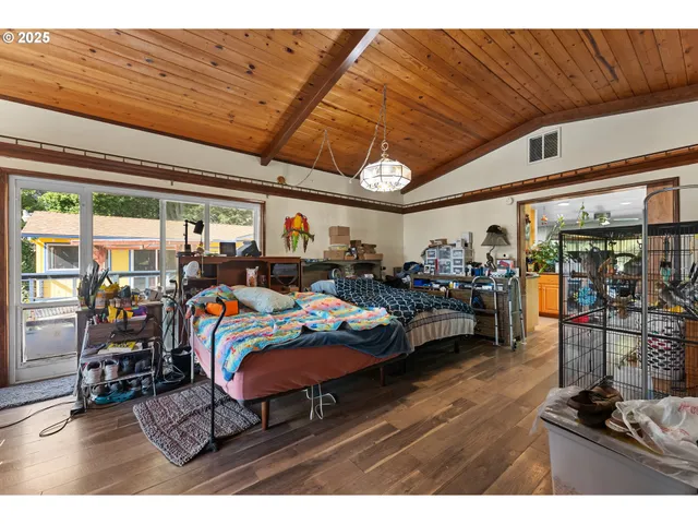 a bedroom with furniture and a large window