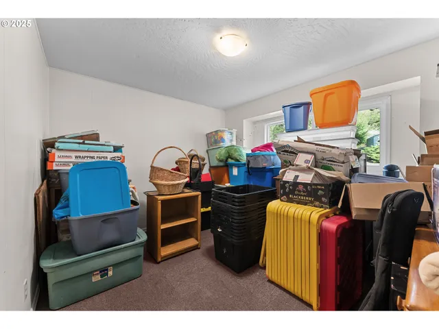 a living room with furniture and a dresser