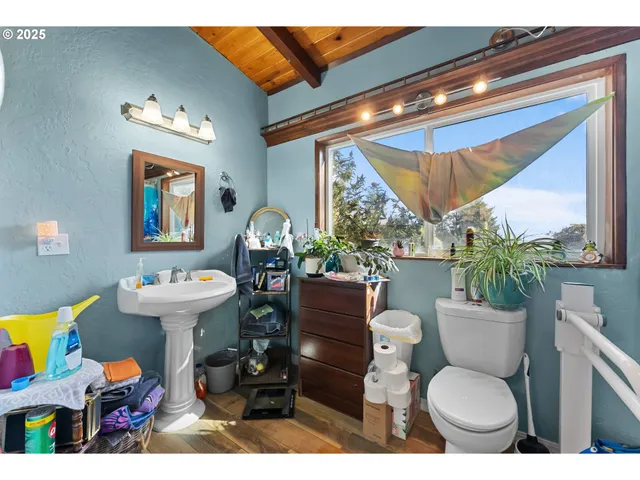 a bathroom with a toilet a sink and a mirror