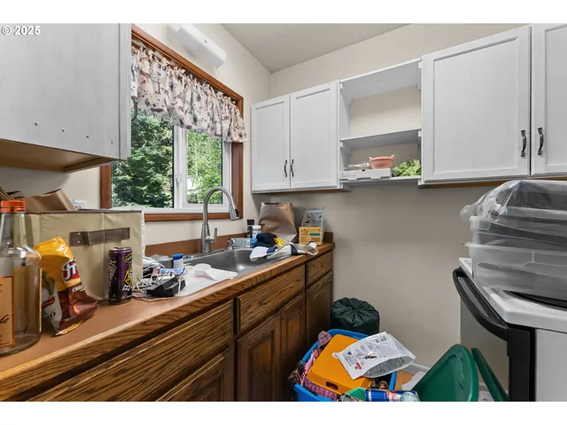 a kitchen with stainless steel appliances a sink a stove and a window