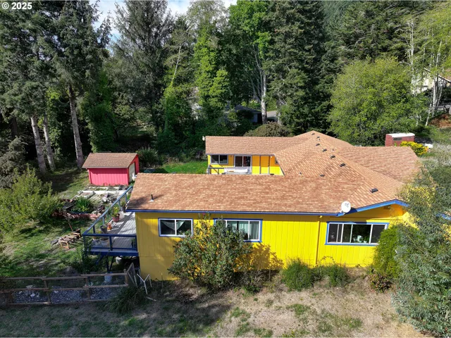 an aerial view of a house with a yard