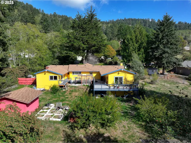 an aerial view of a house with a swimming pool a yard and a yard