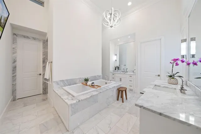 a spacious bathroom with a granite countertop sink a mirror and a shower