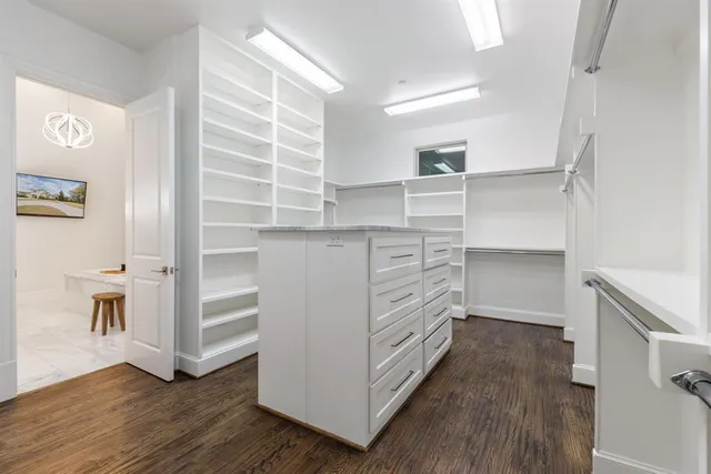 a bedroom with bed and a large window