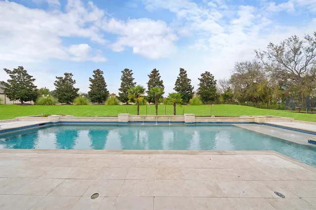 a view of swimming pool with a yard