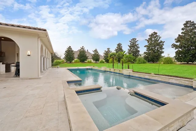 an aerial view of a house with yard swimming pool and outdoor seating
