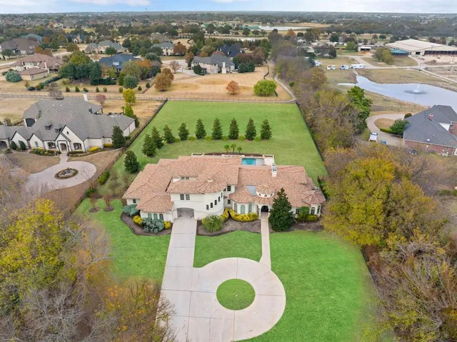an aerial view of a house with garden space and street view