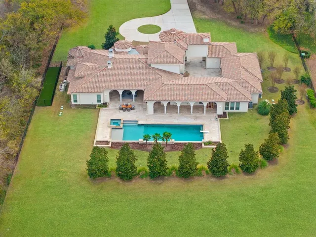 an aerial view of a house with a yard