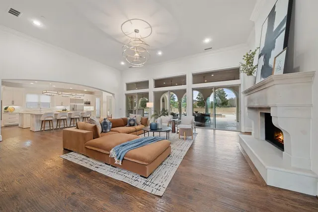 a living room with furniture fireplace and a large window