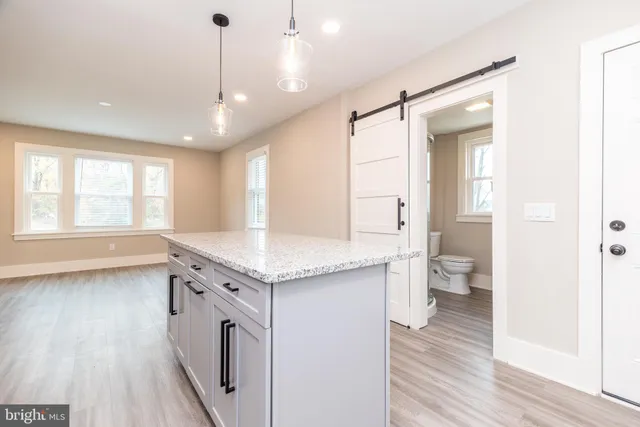 a view of a kitchen with a sink and wooden floor