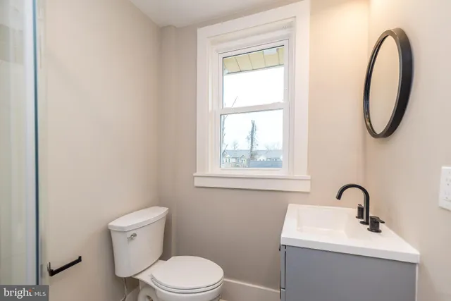 a white toilet sitting next to a bathroom sink