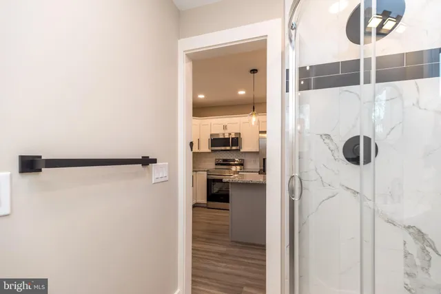 a view of a kitchen from a hallway