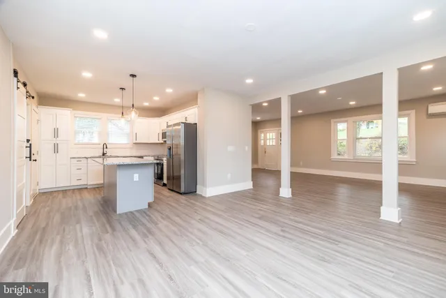 a view of a kitchen with a sink and wooden floor