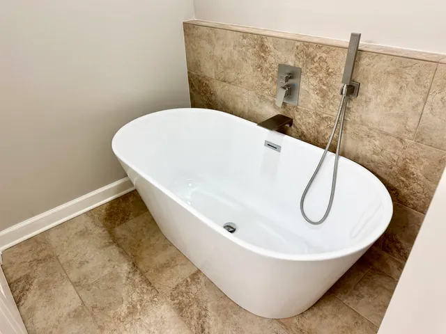 a white bath tub sitting in a bathroom