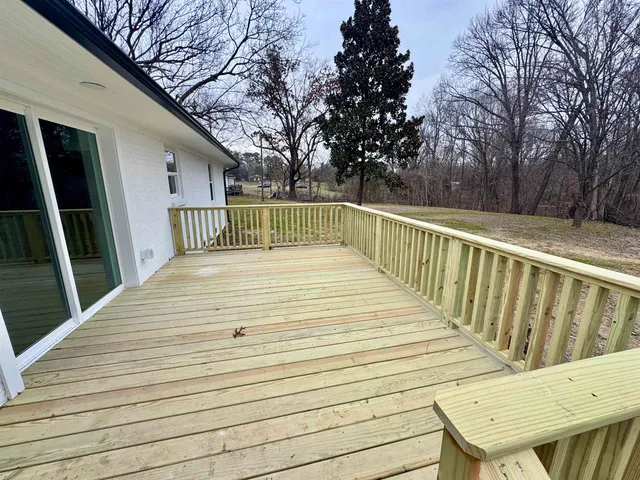 a view of deck with seating and trees