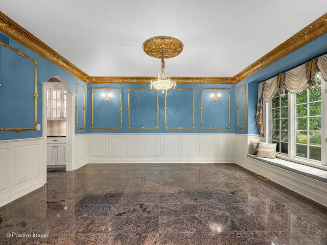 a kitchen with stainless steel appliances kitchen island granite countertop a table chairs sink and cabinets