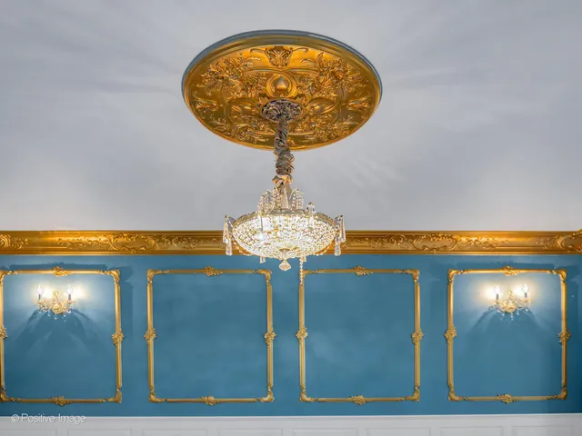 a kitchen with stainless steel appliances granite countertop a refrigerator a stove top oven a sink dishwasher and white cabinets with wooden floor