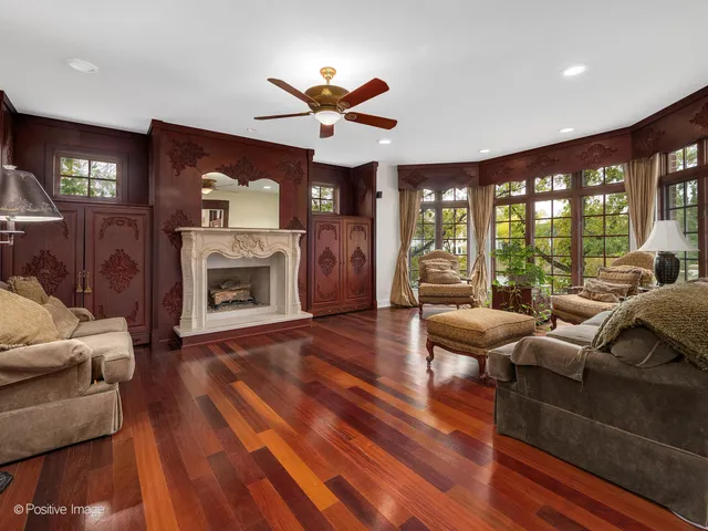 a room with wooden furniture and a large window