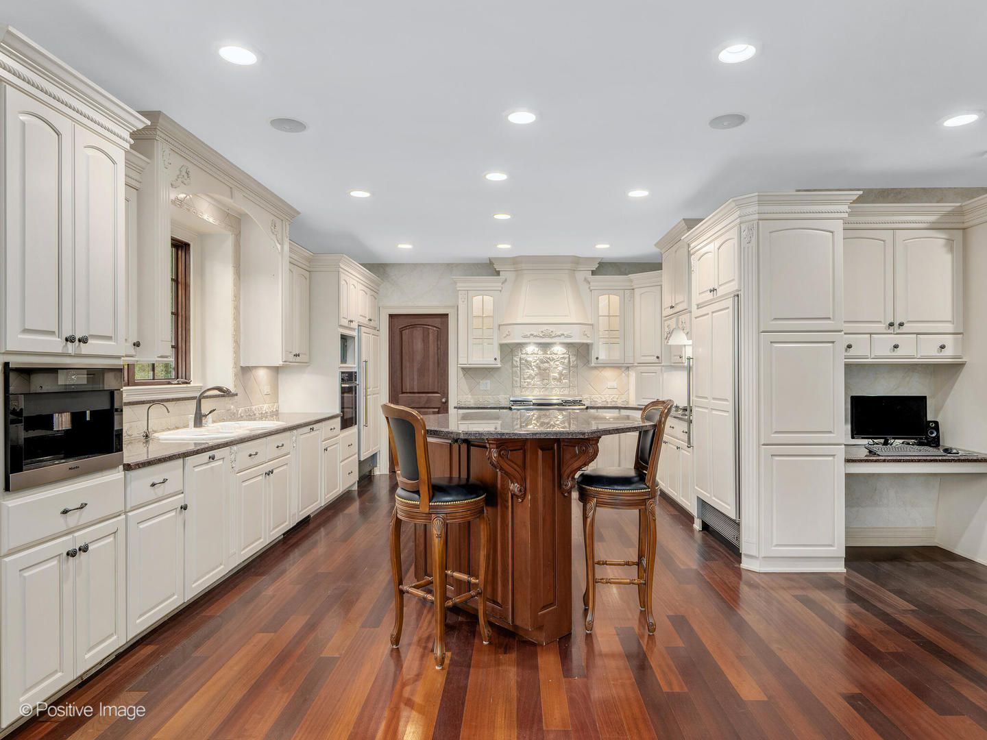 817 Lakeview Lane Burr Ridge, IL 60527 - Photo 35 of 69 a kitchen with stainless steel appliances kitchen island granite countertop a table chairs sink and cabinets