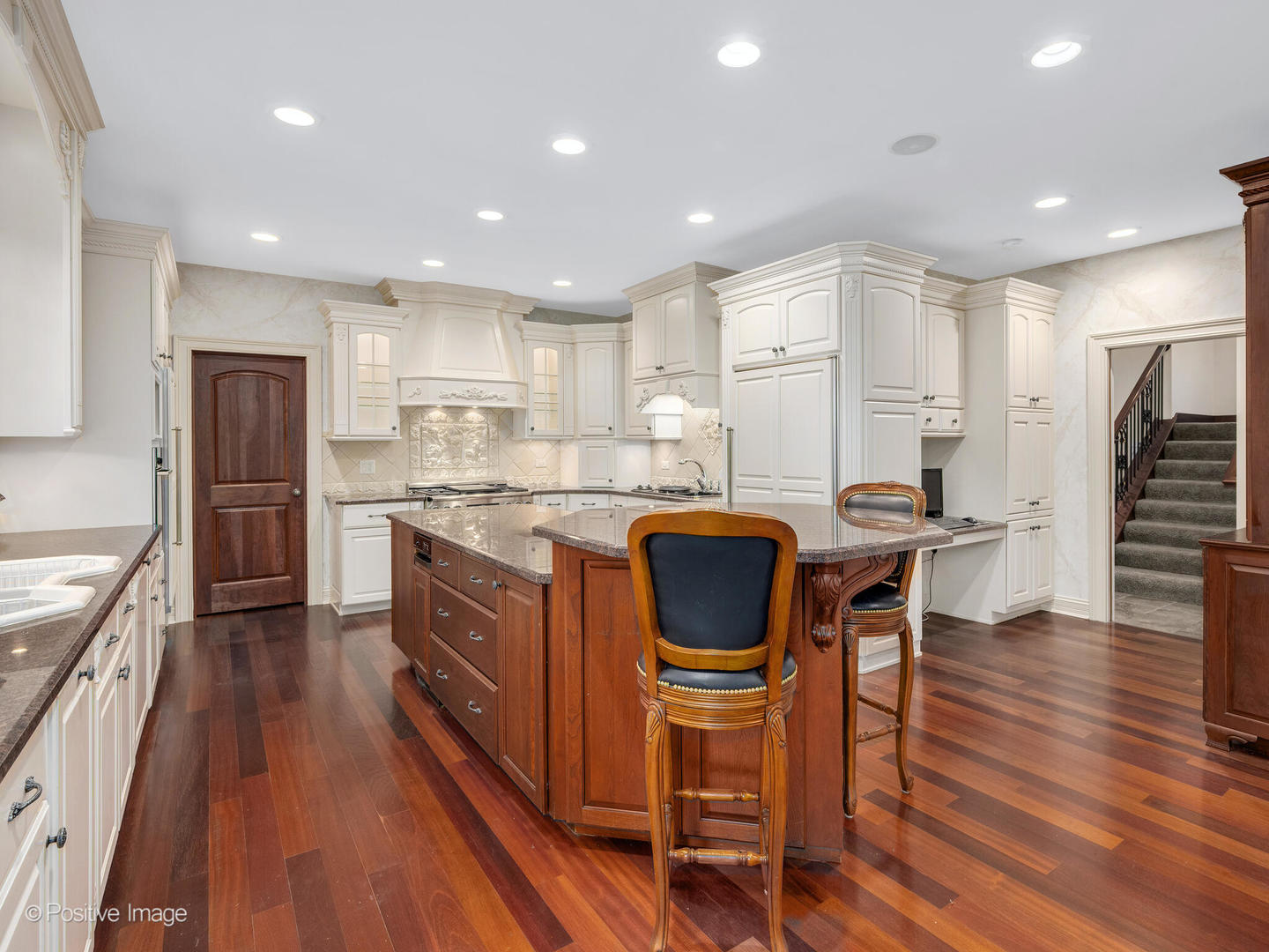 817 Lakeview Lane Burr Ridge, IL 60527 - Photo 36 of 69 a kitchen with stainless steel appliances granite countertop a refrigerator a stove top oven a sink dishwasher and white cabinets with wooden floor