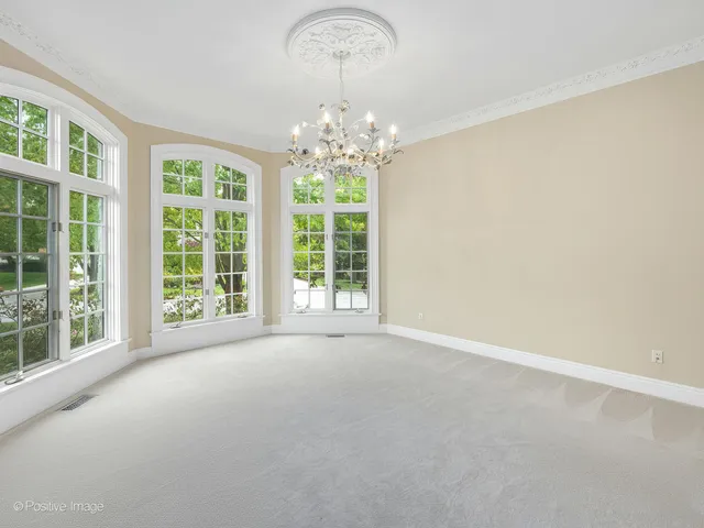 a view of an empty room with window and fire place