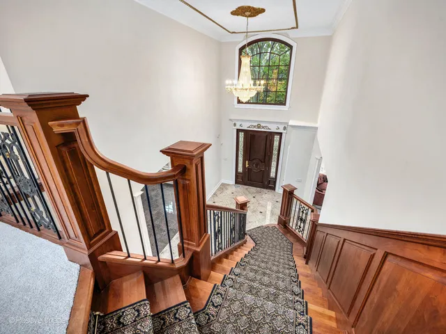 a view of a big room with a fireplace and large windows