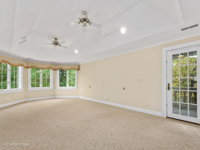 a view of an empty room with window and fire place