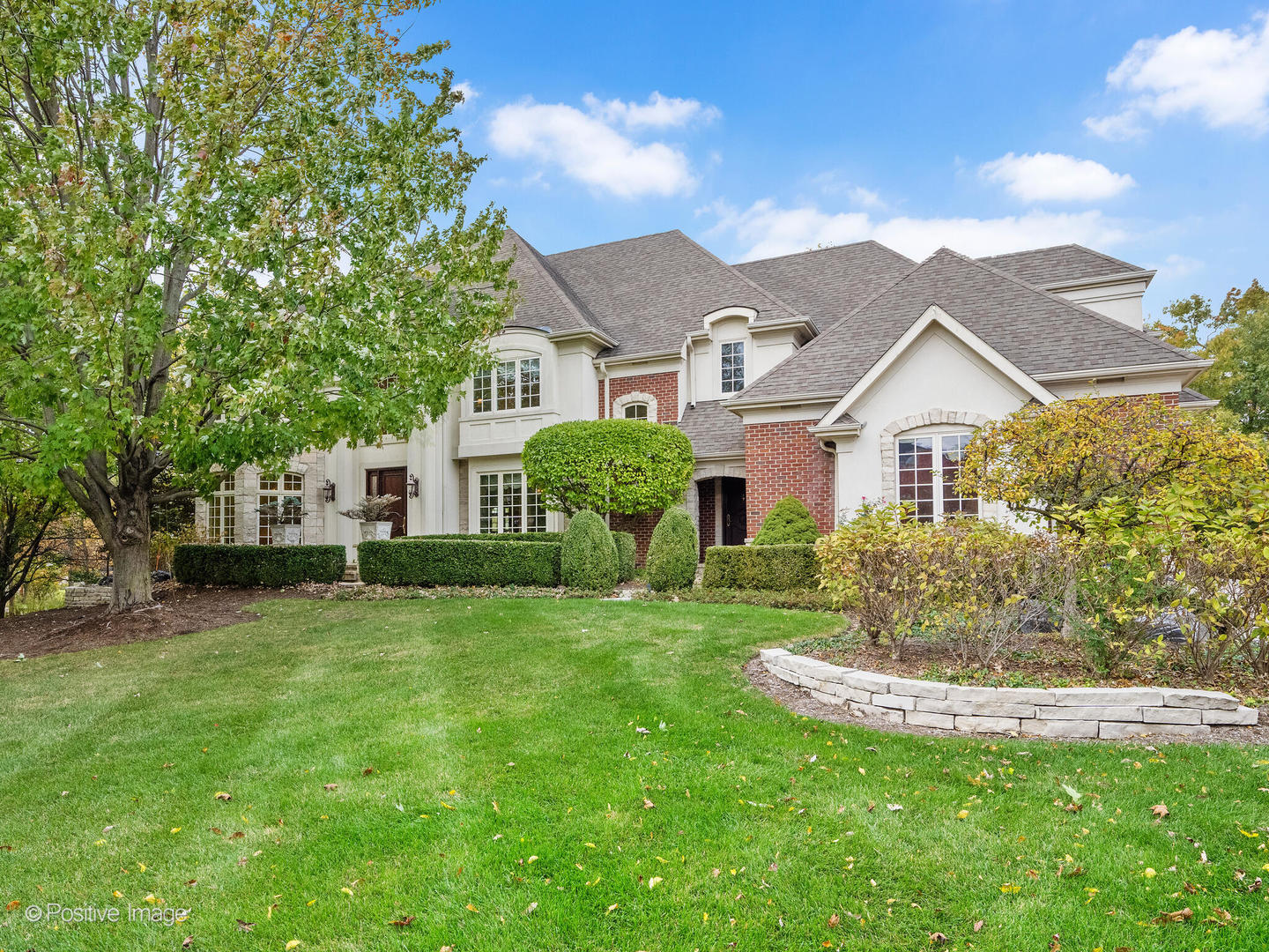 817 Lakeview Lane Burr Ridge, IL 60527 - Photo 5 of 69 a front view of a house with a garden and yard