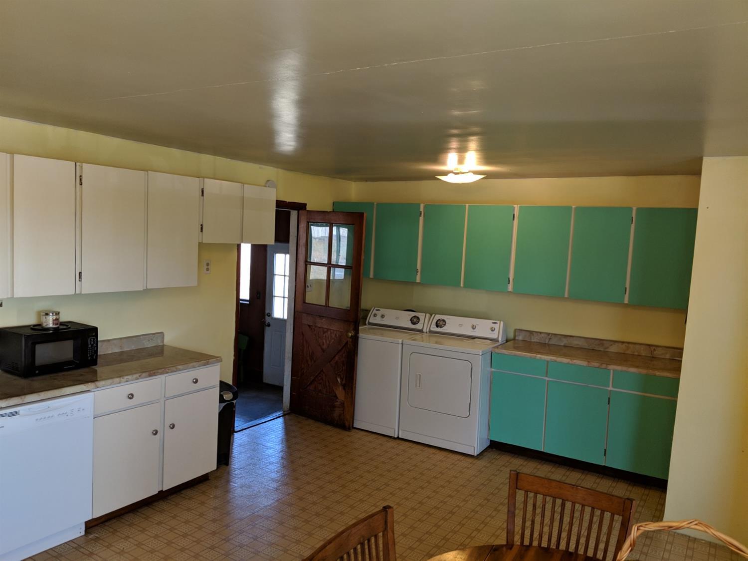 1154 Gibbon Road Central Point, OR 97502 - Photo 6 of 13 a kitchen with green cabinets and white appliances