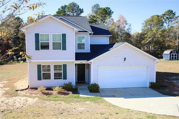 a front view of a house with a yard