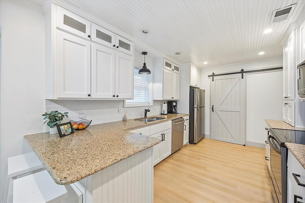 a kitchen with granite countertop cabinets and refrigerator