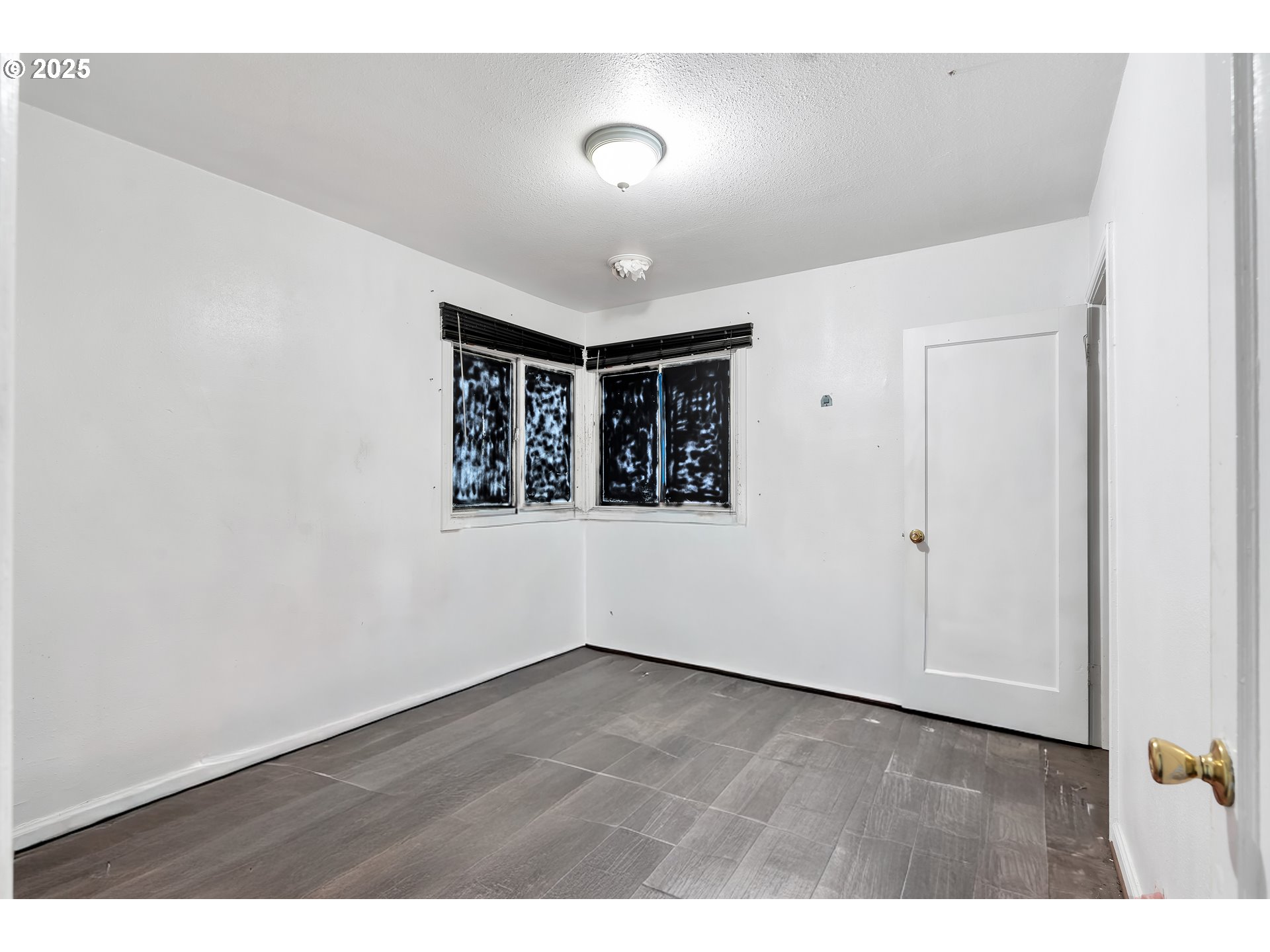 8451 Southeast Bush Street Portland, OR 97266 - Photo 12 of 47 a view of an empty room with wooden floor