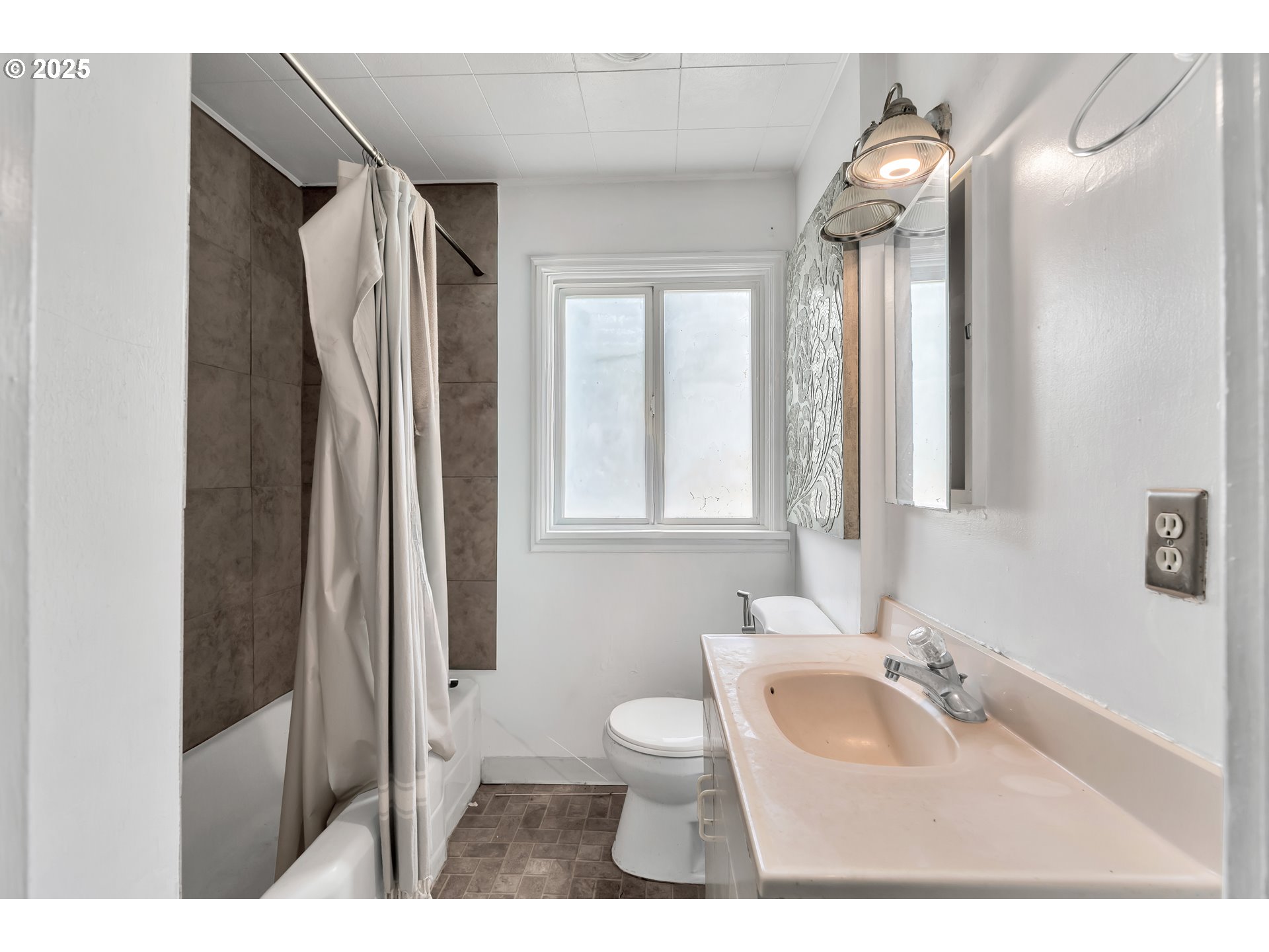 8451 Southeast Bush Street Portland, OR 97266 - Photo 14 of 47 a bathroom with a sink and a mirror