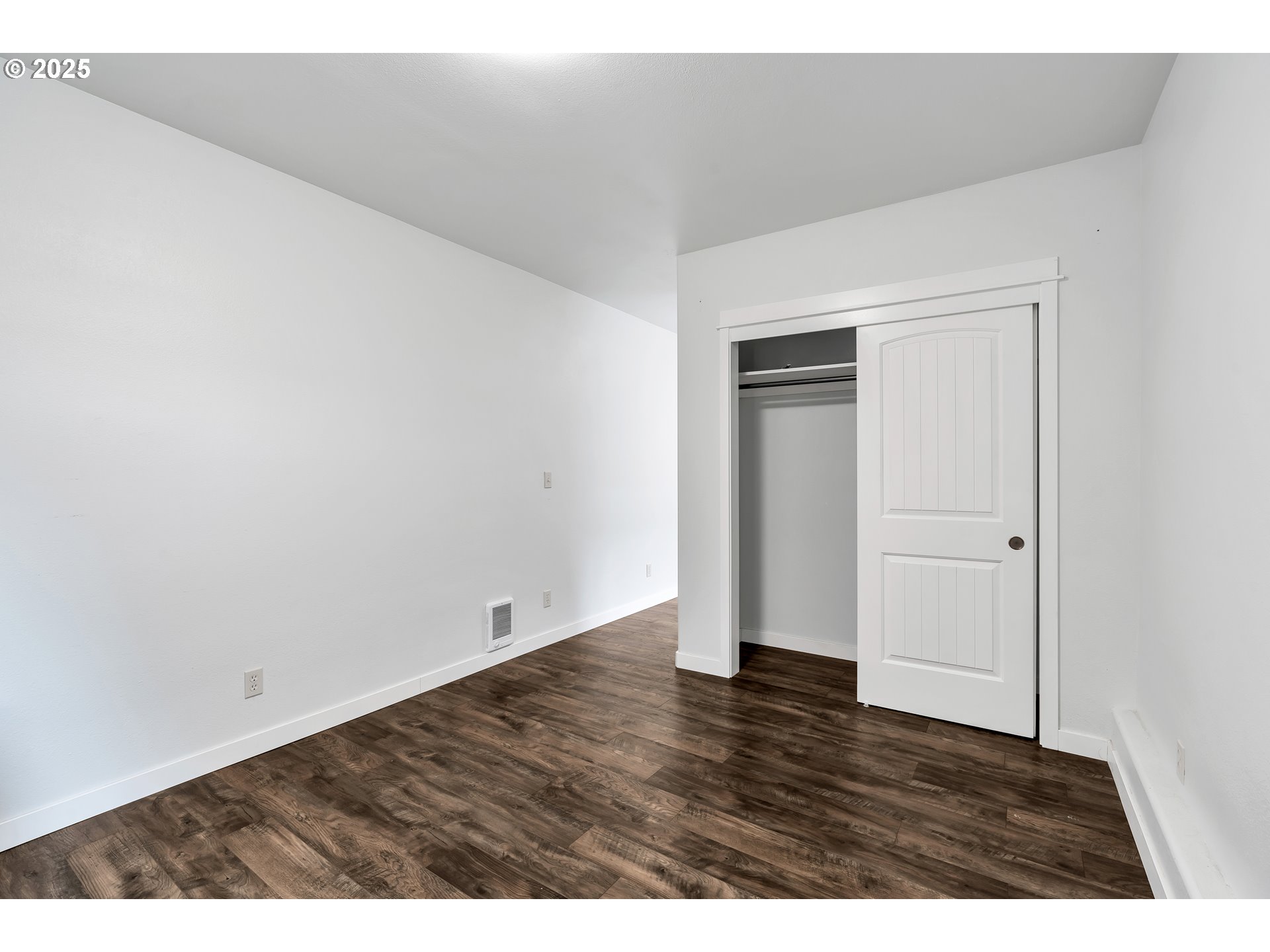8451 Southeast Bush Street Portland, OR 97266 - Photo 28 of 47 a view of an empty room with wooden floor and closet