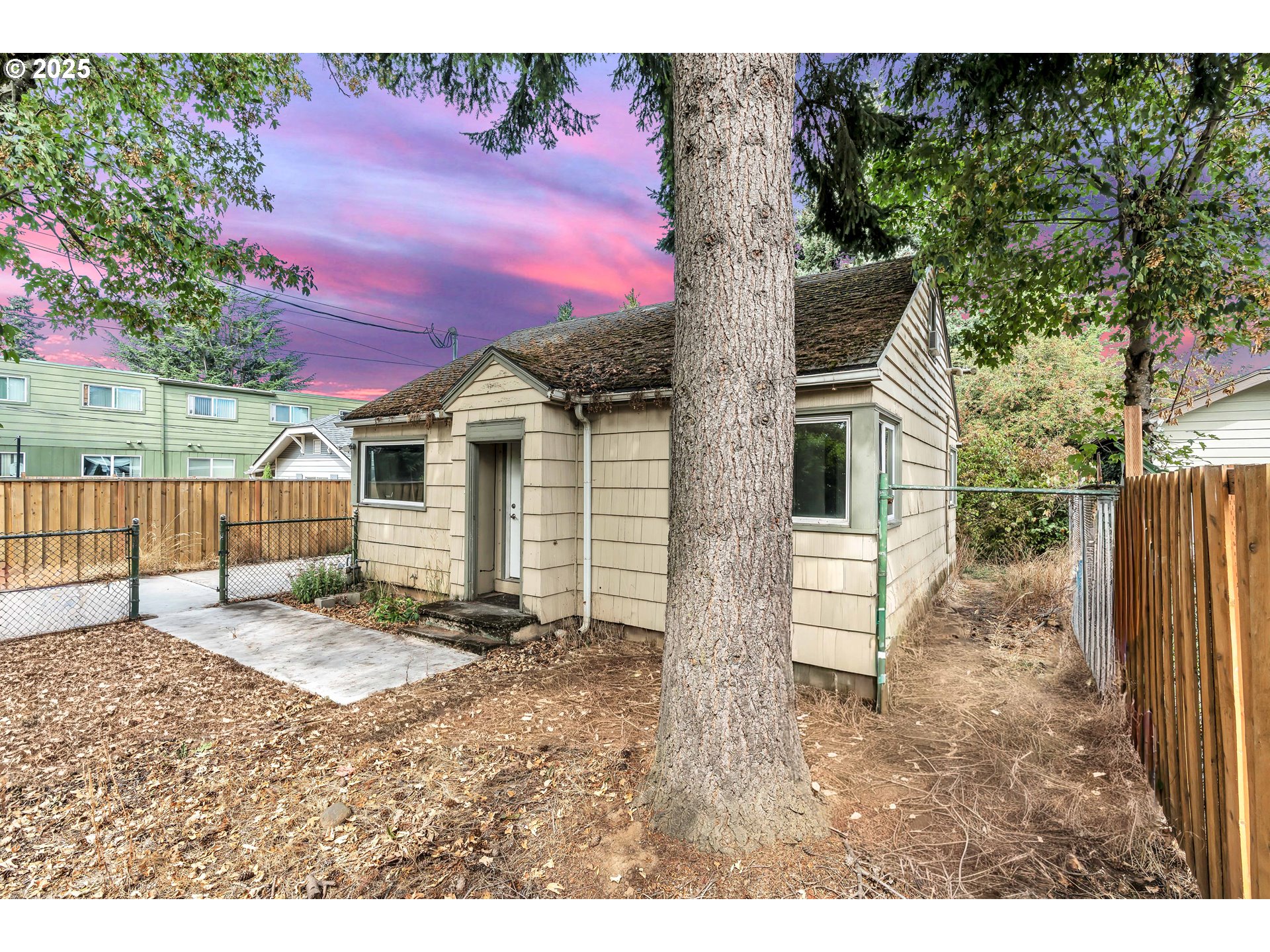 8451 Southeast Bush Street Portland, OR 97266 - Photo 3 of 47 a backyard of a house with table and chairs