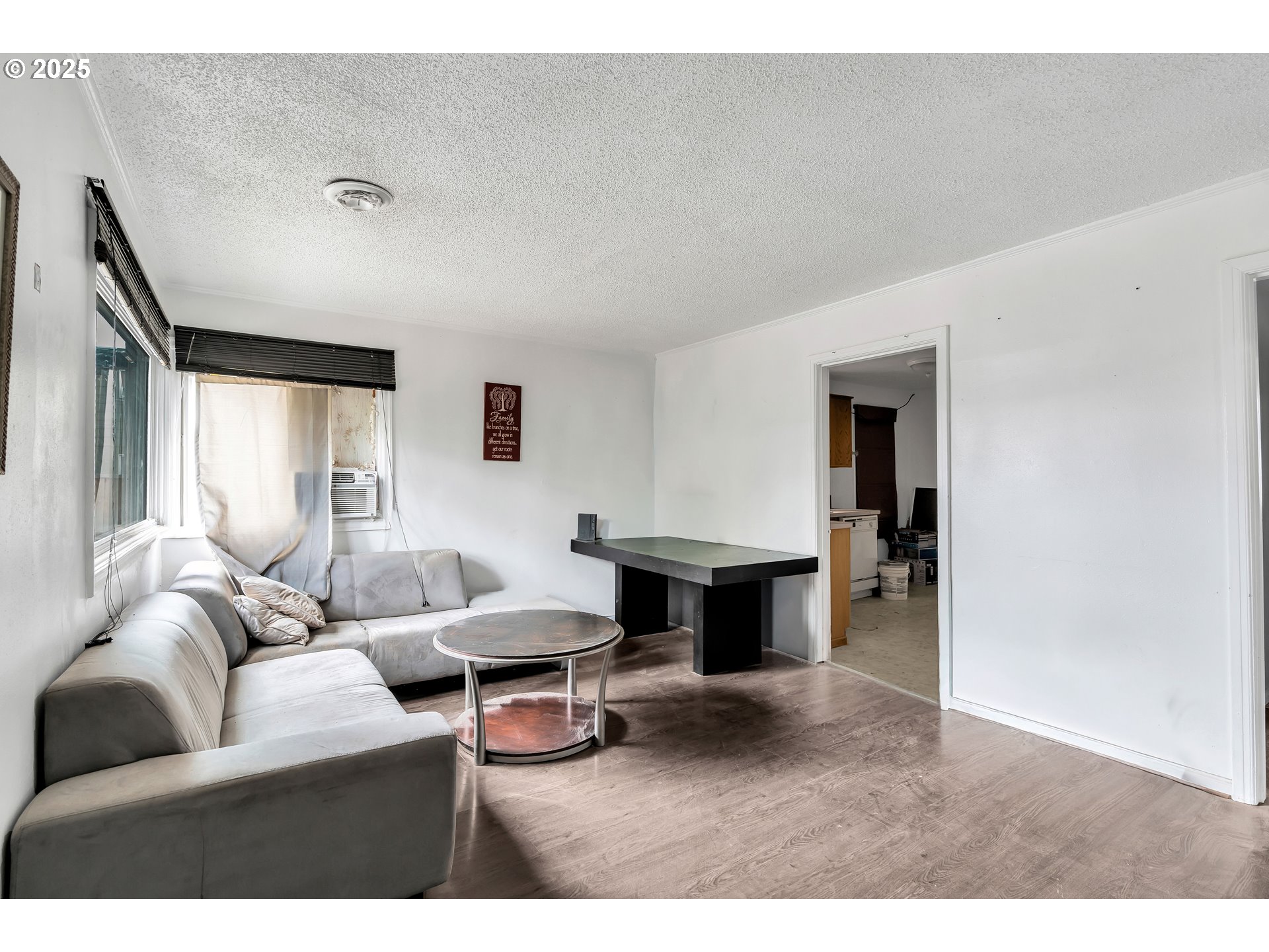 8451 Southeast Bush Street Portland, OR 97266 - Photo 5 of 47 a living room with furniture a window and a wooden floor
