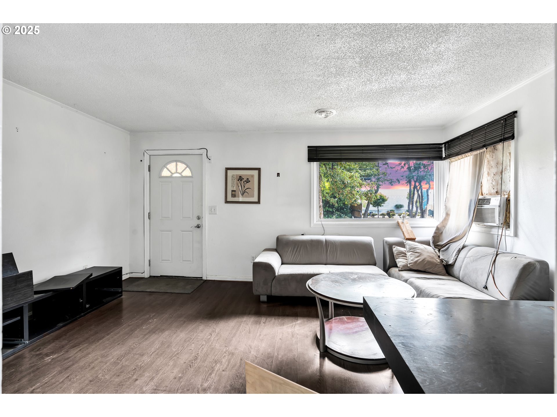 8451 Southeast Bush Street Portland, OR 97266 - Photo 7 of 47 a living room with furniture and a large window