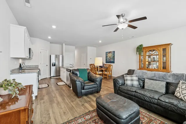 a living room with furniture and kitchen view
