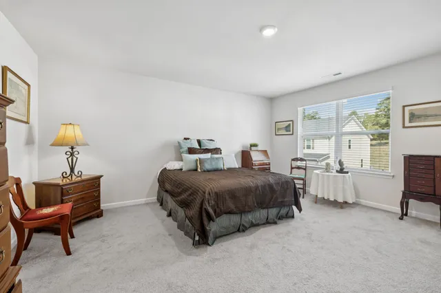 a spacious bedroom with a bed and window