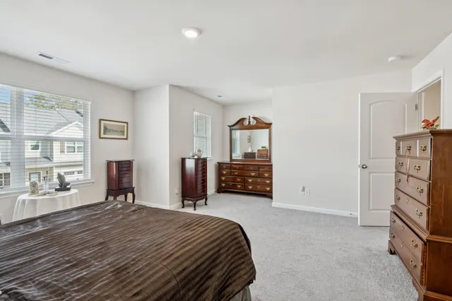 a spacious bedroom with a bed and furniture