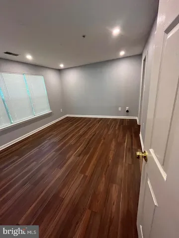 an empty room with wooden floor