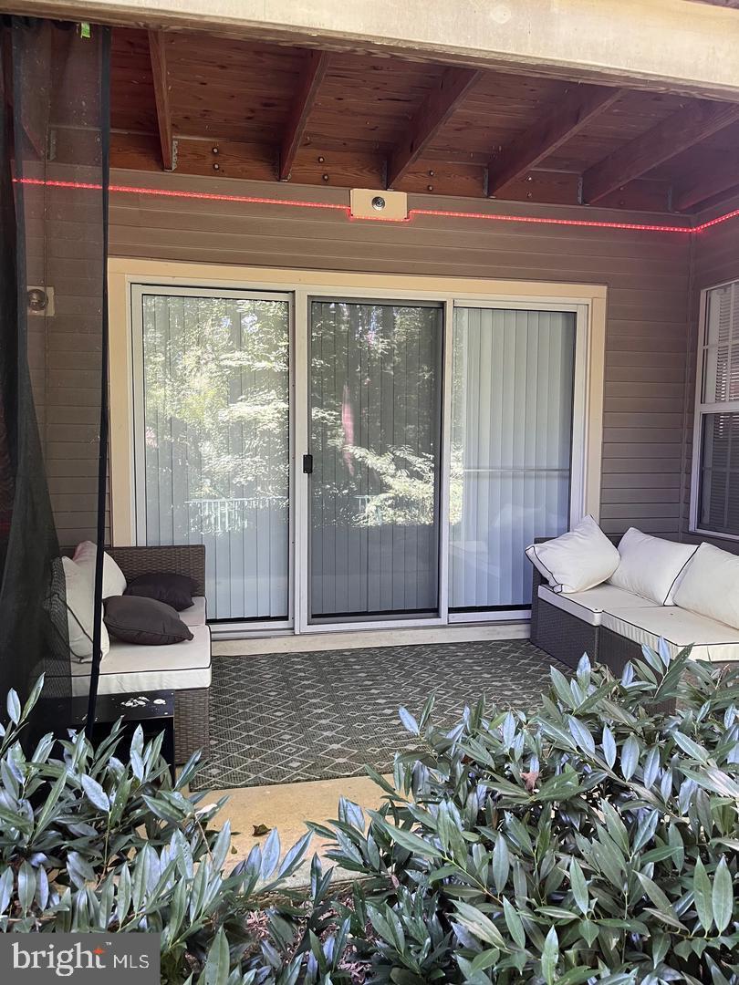 109 Timberbrook Lane, Unit T2 Gaithersburg, MD 20878 - Photo 10 of 10 a living room with furniture and a floor to ceiling window