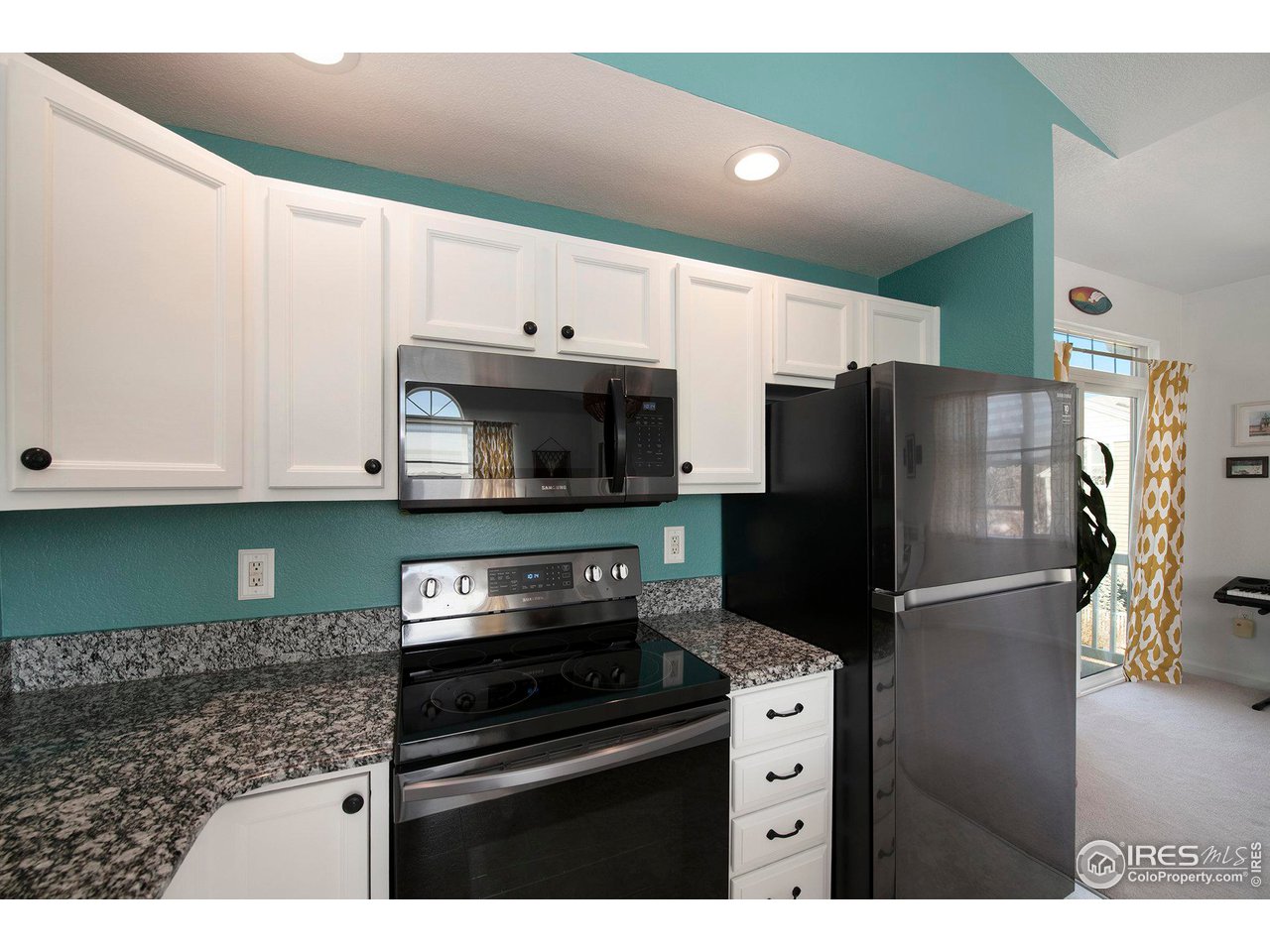 4501 Nelson Road, Unit 2102 Longmont, CO 80503 - Photo 13 of 32 Freshly painted kitchen and cabinets