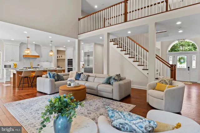 a kitchen with stainless steel appliances kitchen island granite countertop a table chairs and a refrigerator