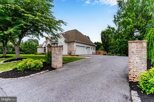 a front view of a house with a garden and yard